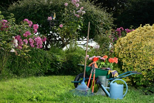 Gardener pruning a compact urban garden in Brixton
